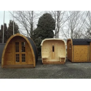 Three wooden camping pods with unique designs, featuring double doors, benches, and natural wood finishes, ideal for outdoor use.