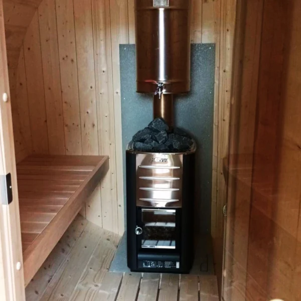 Spacious 3.3m barrel sauna with terrace and changing room. Ideal for outdoor relaxation and authentic sauna experiences.